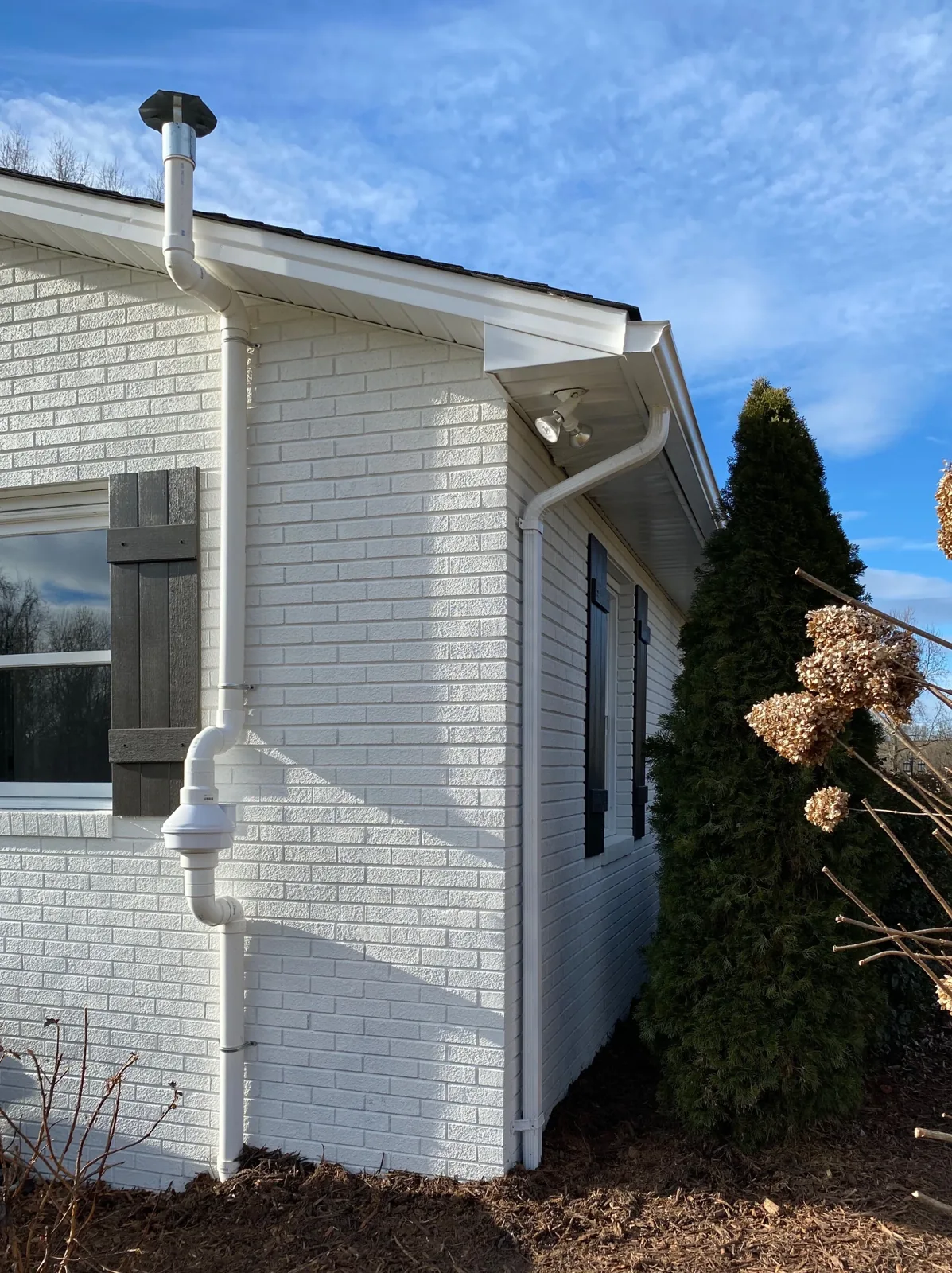 Exterior piping at a brick home from the original radon project gallery